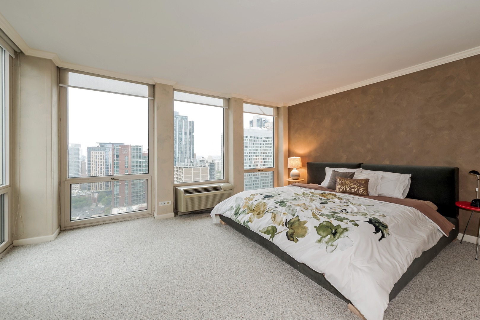111 East Chestnut Street, Unit 29K Chicago, IL 60611 - Photo 6 of 10 a bed sitting in a bedroom next to a large window