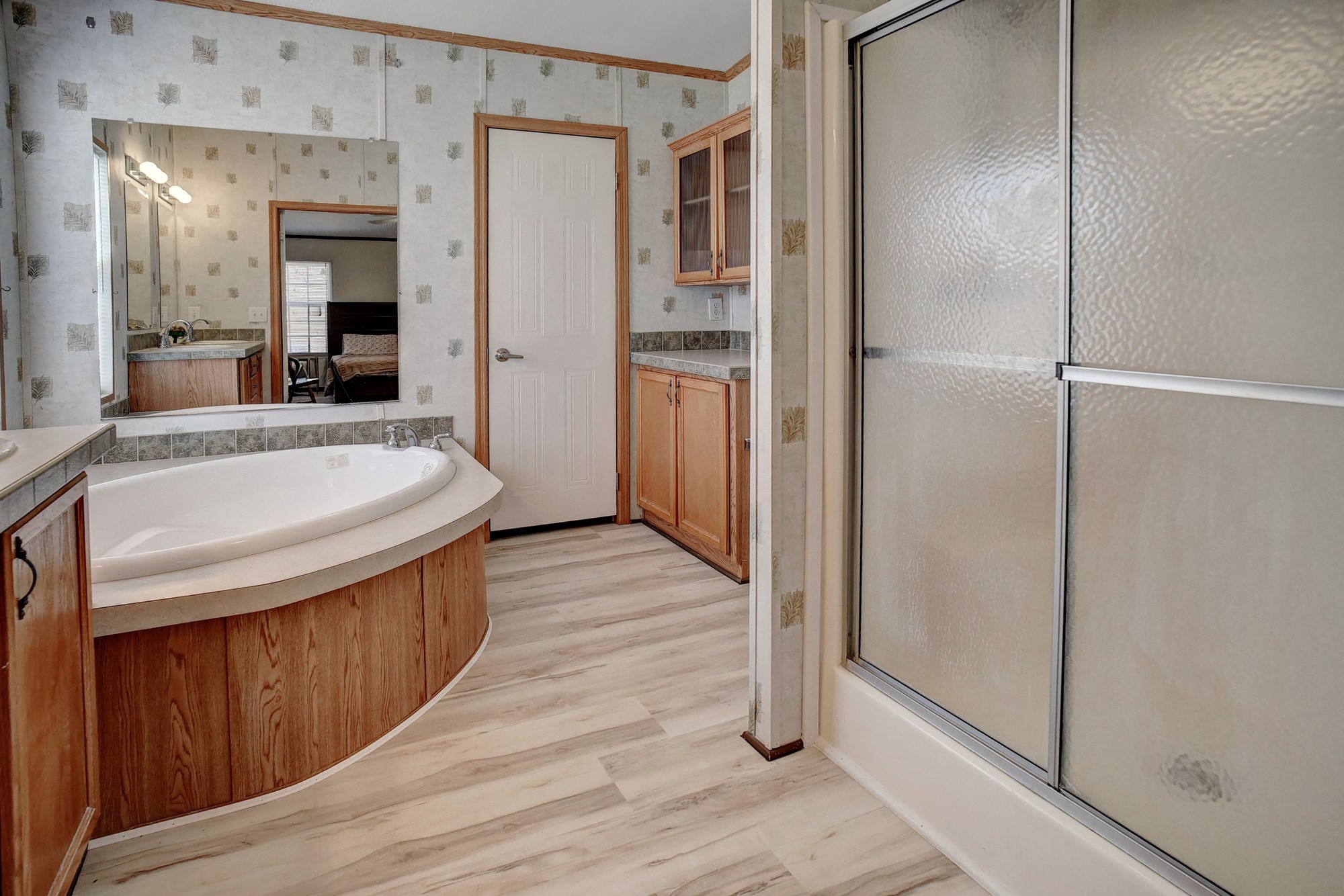 552 South Old Potato Road Paige, TX 78659 - Photo 18 of 40 The natural wood accents add to the charm of this spacious primary bathroom.