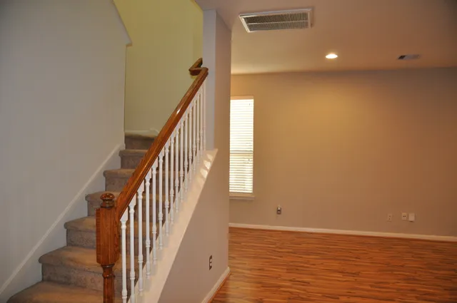a view of hallway with wooden floor