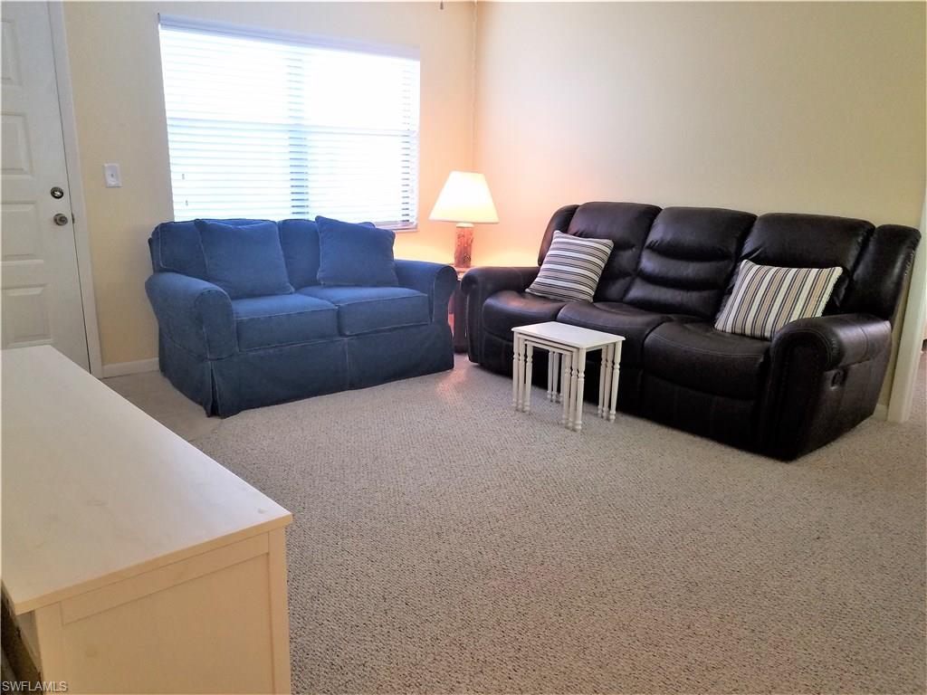 4363 27th Court Southwest, Unit 2103 Naples, FL 34116 - Photo 2 of 15 a living room with furniture and a window