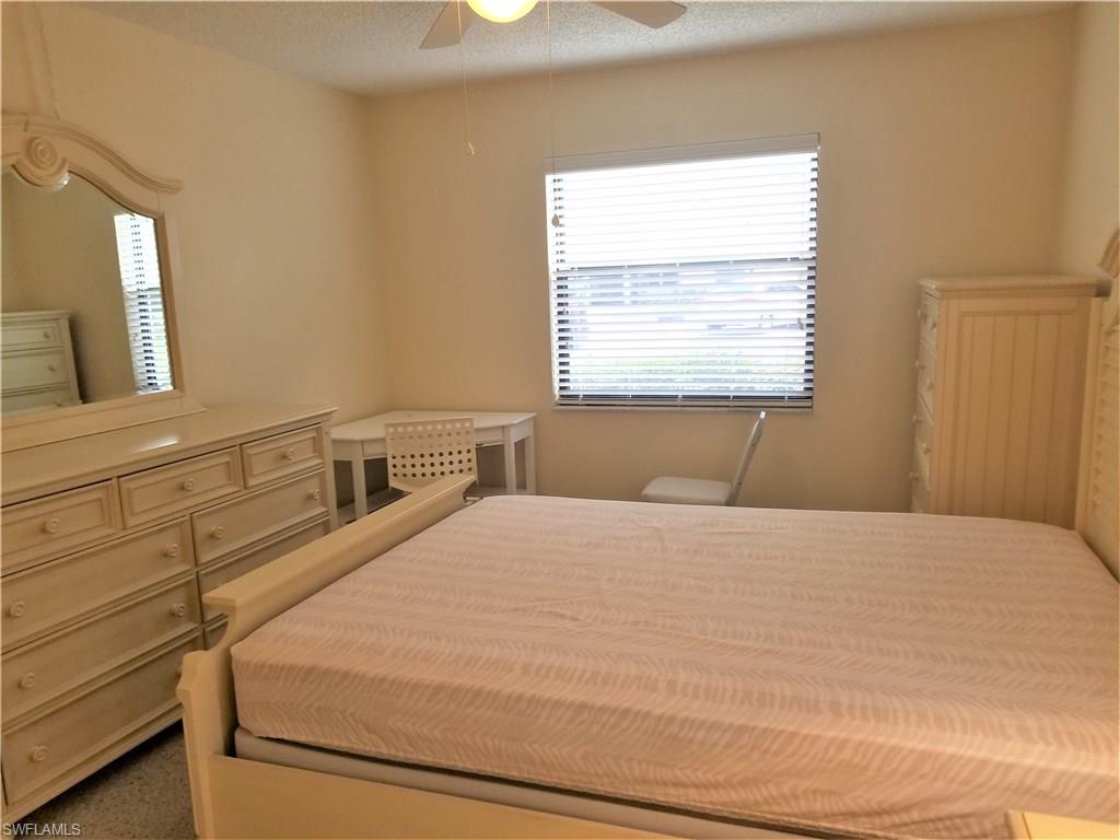4363 27th Court Southwest, Unit 2103 Naples, FL 34116 - Photo 10 of 15 a bedroom with a bed and a window