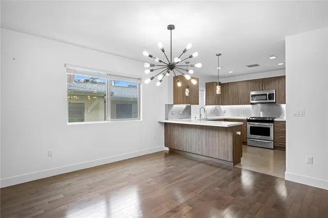 a large kitchen with kitchen island a sink counter space and stainless steel appliances