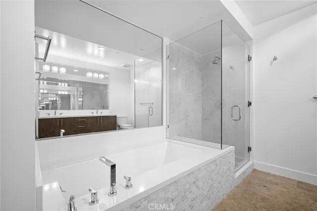 a bathroom with a tub a sink and shower