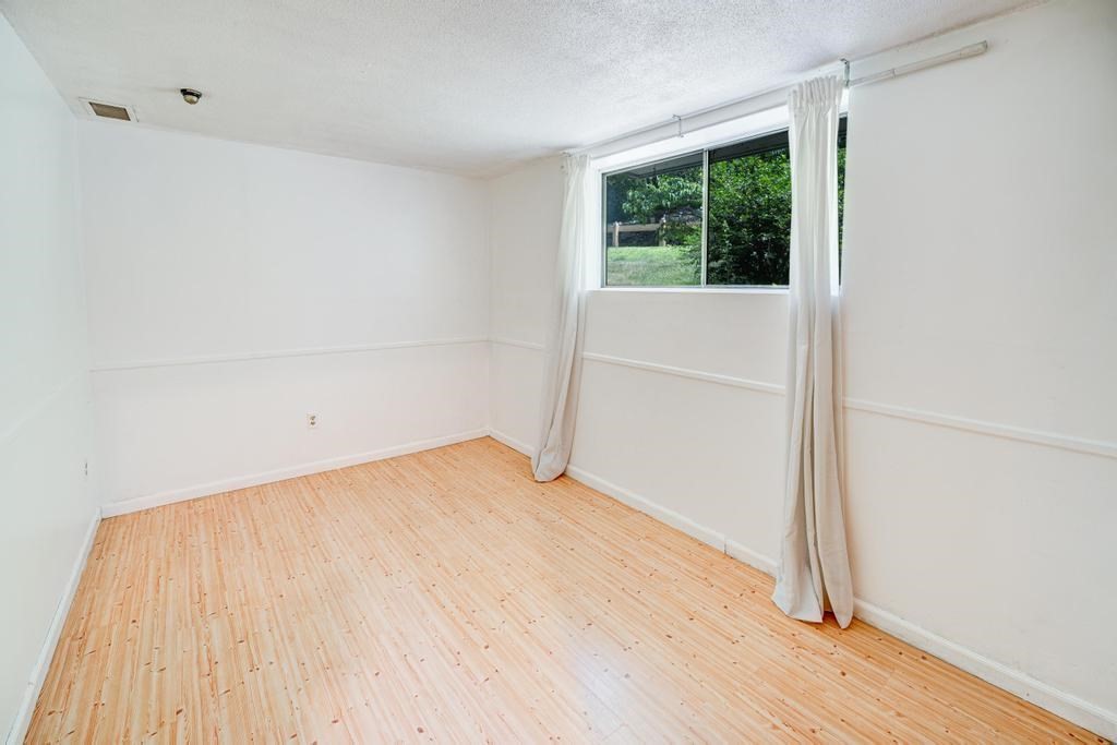 376 Great Road, Unit 15 Acton, MA 01720 - Photo 19 of 27 an empty room with wooden floor and windows