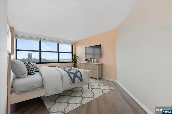 a view of an empty room with wooden floor