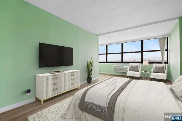 a living room with furniture and large windows