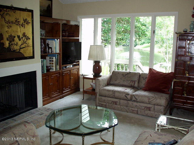 9 Players Club Villas Road Ponte Vedra Beach, FL 32082 - Photo 11 of 21 a living room with furniture a lamp and a fireplace