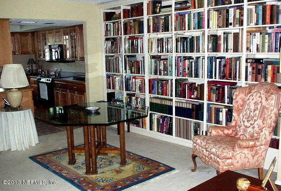 9 Players Club Villas Road Ponte Vedra Beach, FL 32082 - Photo 13 of 21 a living room with furniture and a book shelf