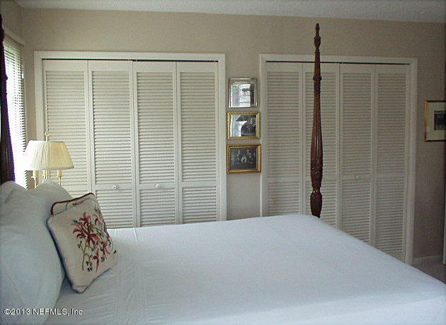 9 Players Club Villas Road Ponte Vedra Beach, FL 32082 - Photo 17 of 21 a bedroom with a bed and wooden floor