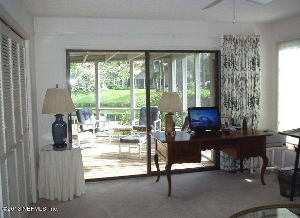 9 Players Club Villas Road Ponte Vedra Beach, FL 32082 - Photo 18 of 21 a living room with furniture and a floor to ceiling window