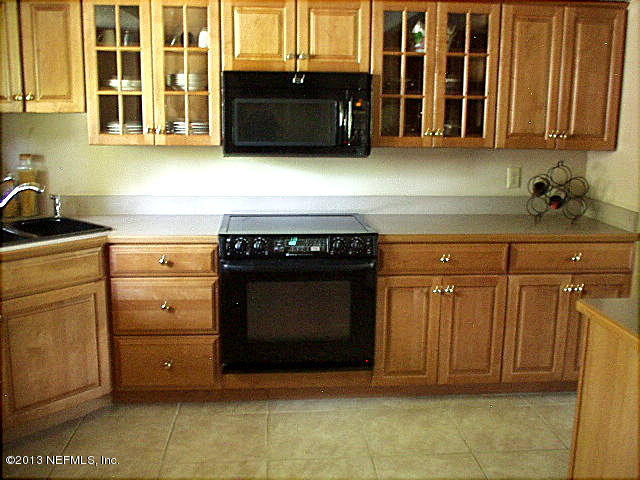 9 Players Club Villas Road Ponte Vedra Beach, FL 32082 - Photo 2 of 21 a kitchen with granite countertop a stove top oven and cabinets
