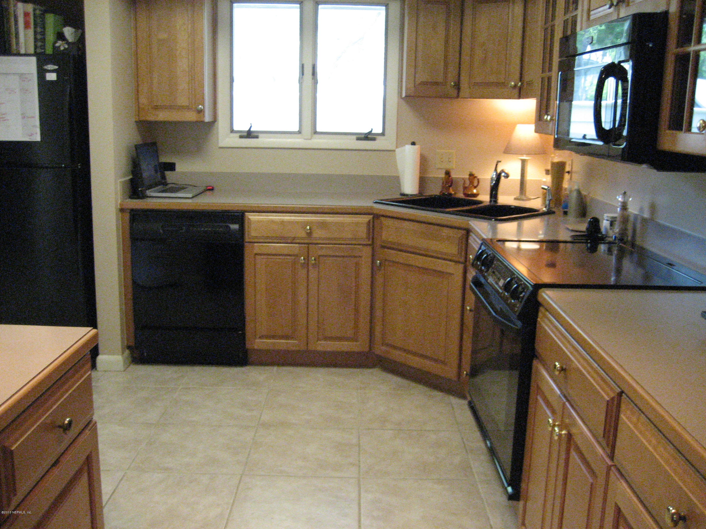 9 Players Club Villas Road Ponte Vedra Beach, FL 32082 - Photo 3 of 21 a kitchen with a sink and cabinets