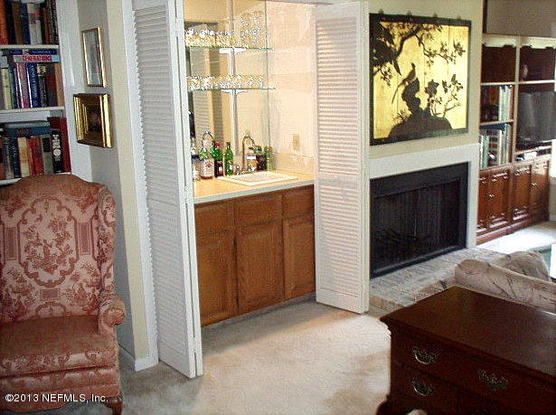 9 Players Club Villas Road Ponte Vedra Beach, FL 32082 - Photo 5 of 21 a living room with a fireplace furniture and a book shelf