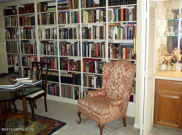 9 Players Club Villas Road Ponte Vedra Beach, FL 32082 - Photo 6 of 21 a living room with furniture and a book shelf