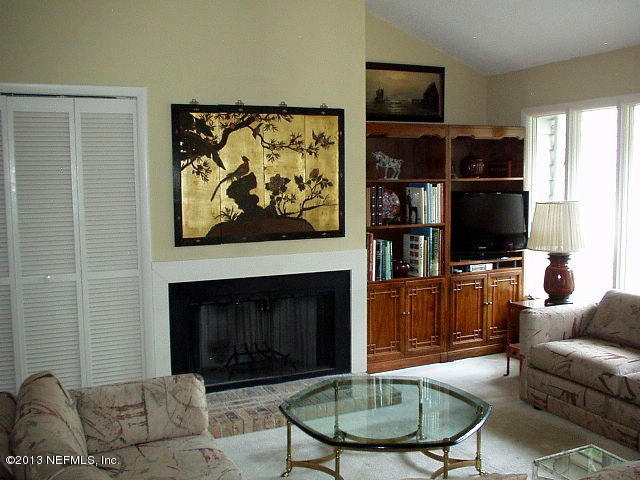 9 Players Club Villas Road Ponte Vedra Beach, FL 32082 - Photo 10 of 21 a living room with furniture a flat screen tv and a fireplace