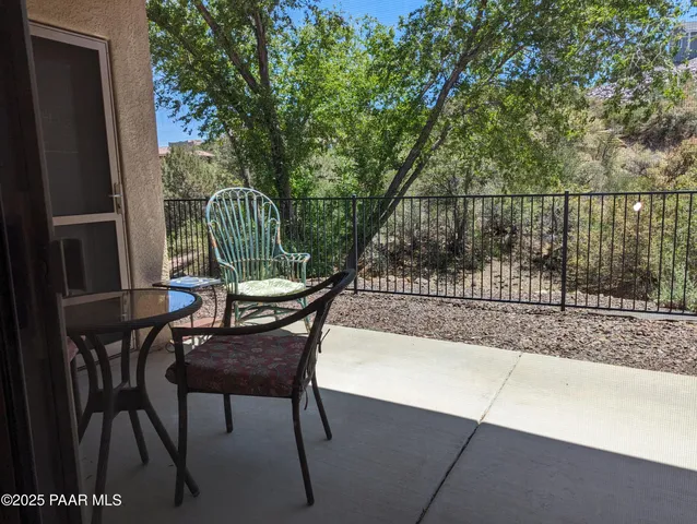 a view of a chair and table in the patio