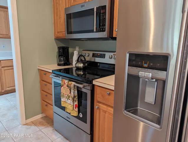 a kitchen with stainless steel appliances granite countertop a stove and a microwave