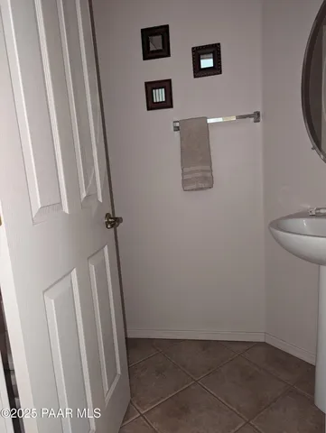 a view of a hallway with wooden floor and a cabinet