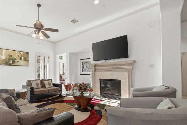 a living room with furniture a fireplace and a flat screen tv
