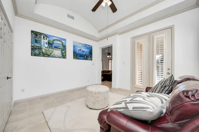 a bedroom with furniture and a large window