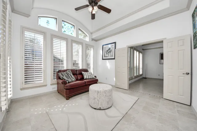 a living room with furniture and windows