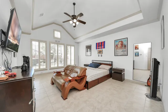 a dining room with a window and chandelier