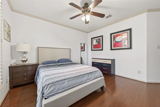 a spacious bedroom with a bed and a chandelier
