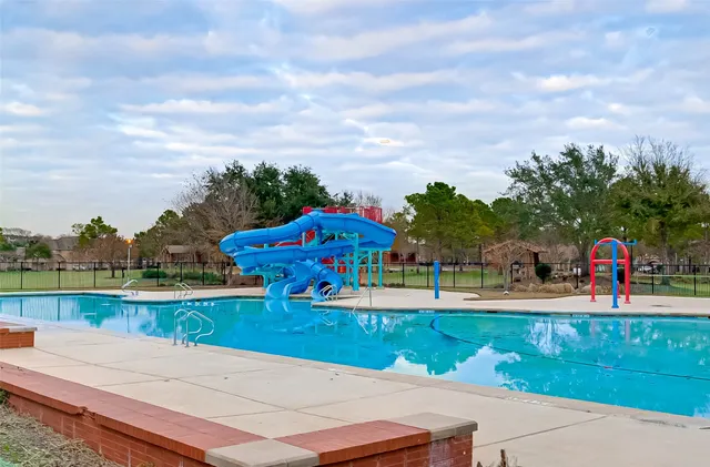 a view of a park with swings and slides