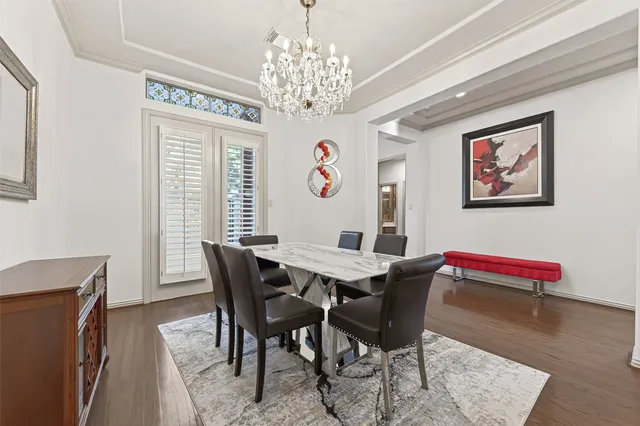 a view of a dining room with furniture wooden floor and chandelier