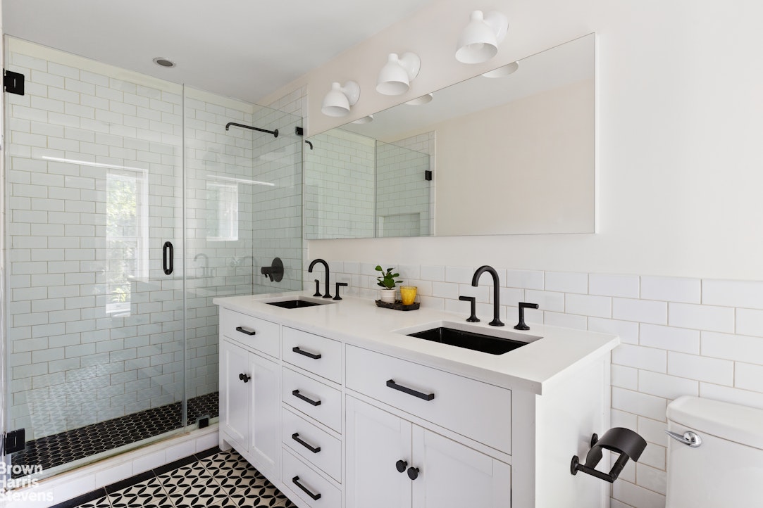 210 Macon Street Brooklyn, NY 11216 - Photo 8 of 13 a kitchen with a sink a stove a refrigerator and cabinets