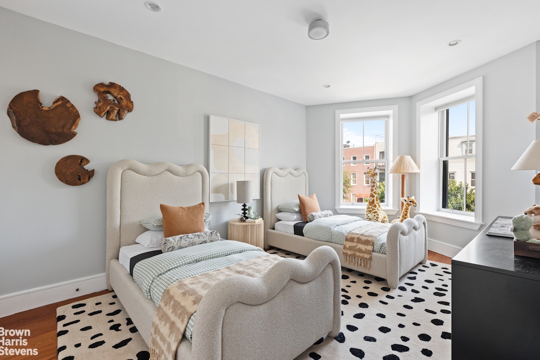 210 Macon Street Brooklyn, NY 11216 - Photo 9 of 13 a bedroom with furniture and a window
