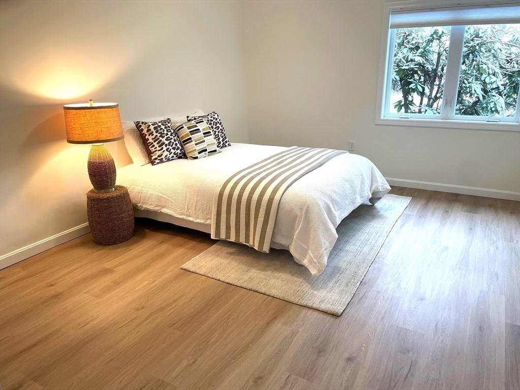 2 Duck Pond Road, Unit 108 Beverly, MA 01915 - Photo 11 of 17 a large bed sitting in a bedroom next to a window