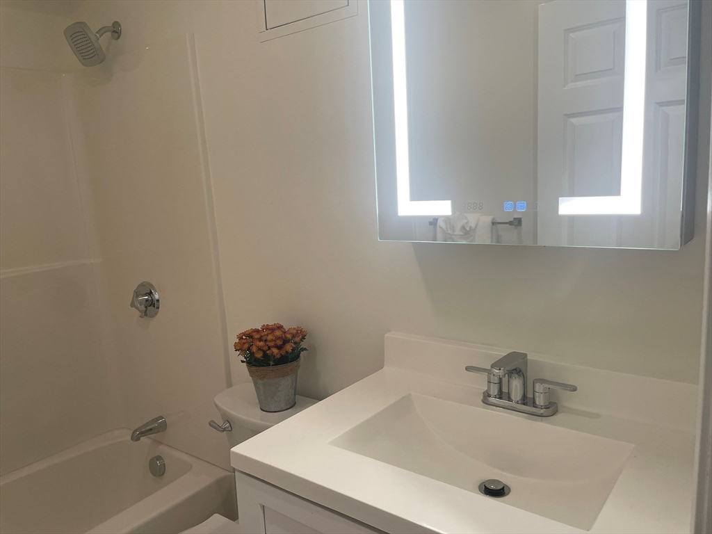 2 Duck Pond Road, Unit 108 Beverly, MA 01915 - Photo 13 of 17 a bathroom with a sink and a tub