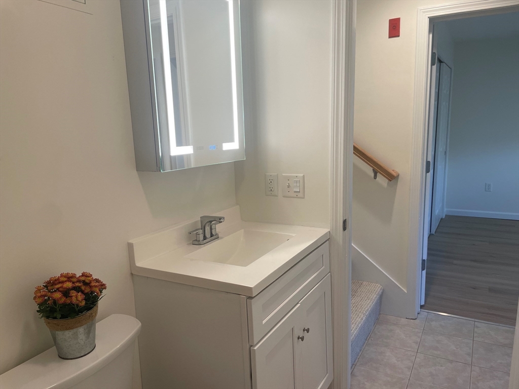 2 Duck Pond Road, Unit 108 Beverly, MA 01915 - Photo 14 of 17 a bathroom with a sink vanity and a mirror
