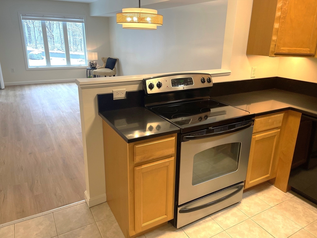 2 Duck Pond Road, Unit 108 Beverly, MA 01915 - Photo 3 of 17 a kitchen with a stove and a microwave