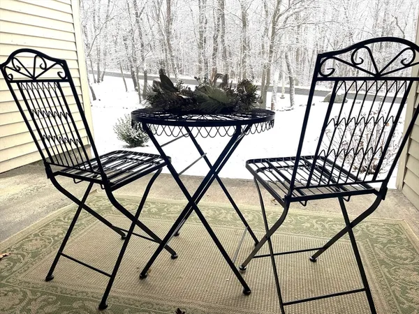 a view of a chairs and bench on the roof deck