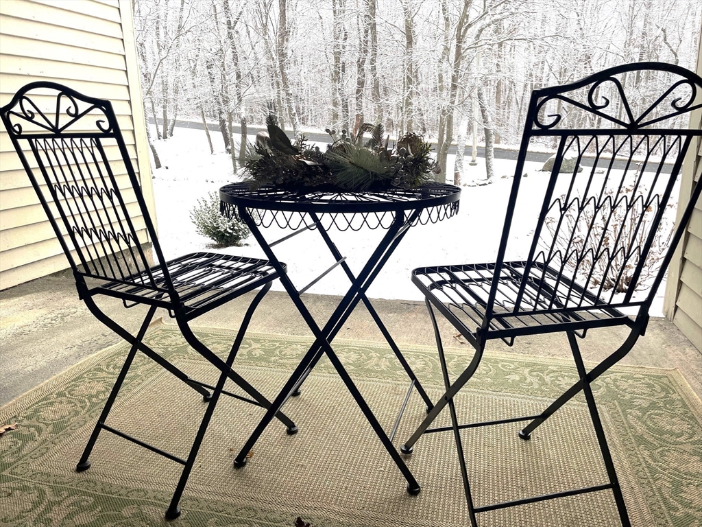 2 Duck Pond Road, Unit 108 Beverly, MA 01915 - Photo 8 of 17 a view of a chairs and bench on the roof deck