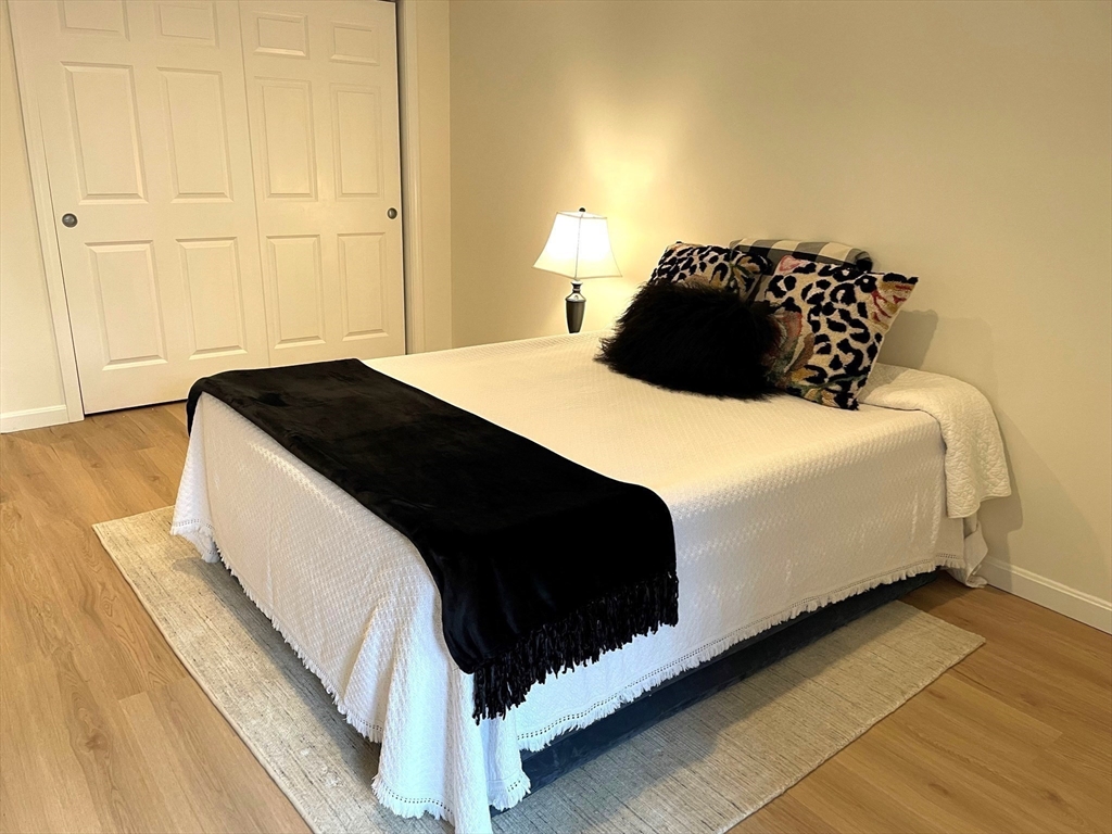 2 Duck Pond Road, Unit 108 Beverly, MA 01915 - Photo 9 of 17 a bedroom with a bed and a chair