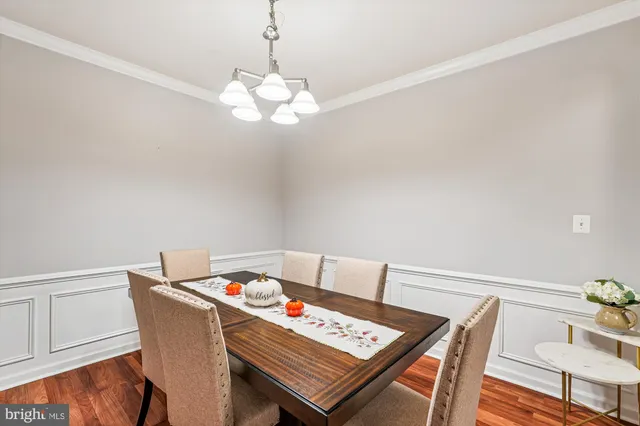 a view of a dining room with furniture wooden floor and chandelier