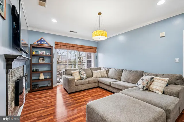 a living room with fireplace furniture and a flat screen tv