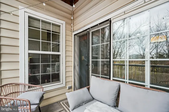 a balcony with a couch and large window