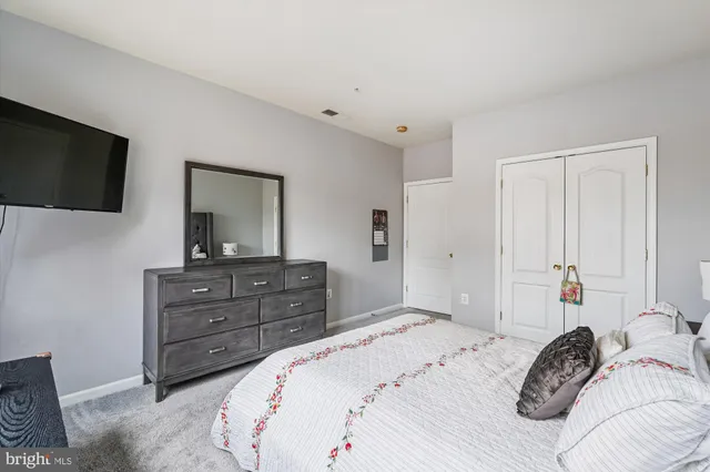 a bedroom with a bed and a television