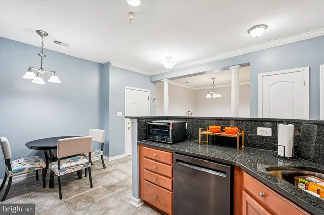 a kitchen with stainless steel appliances granite countertop a sink and a refrigerator