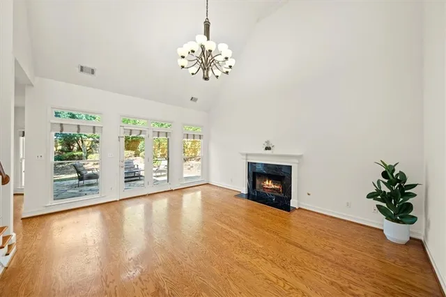 a view of an empty room with a fireplace and a window