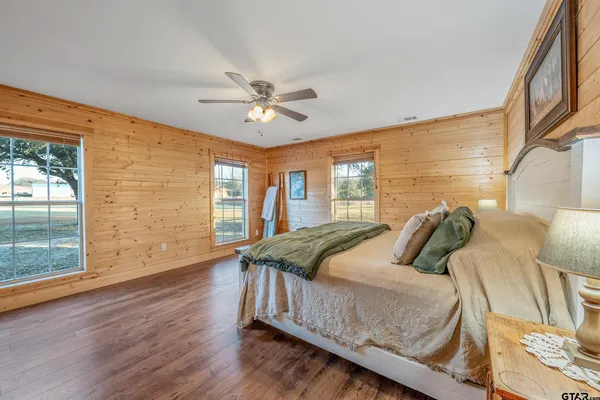 a bathroom with a double vanity sink a mirror and a bathtub