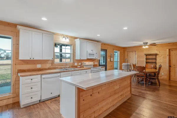 a room with granite countertop white cabinets and a sink
