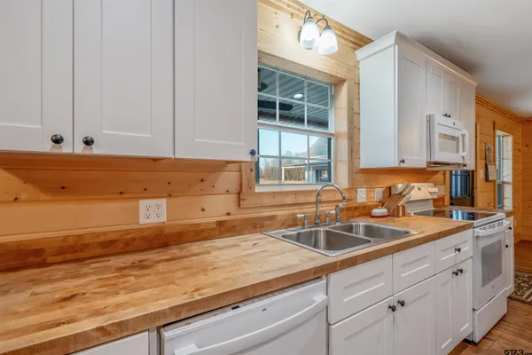 a kitchen with sink stove and cabinets