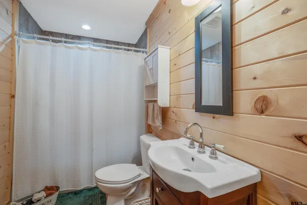 a bed room with a bed and a ceiling fan