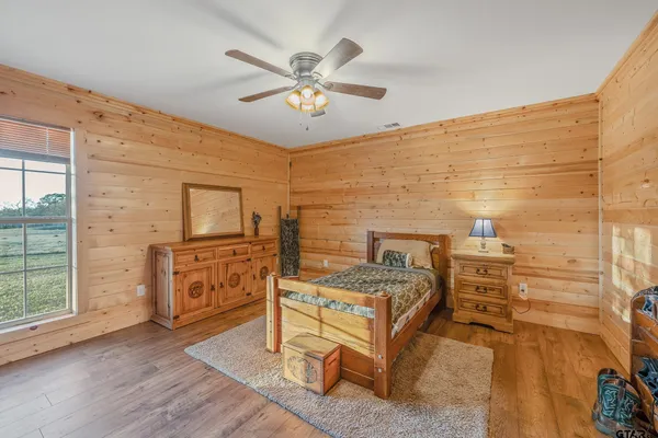 a view of a room with chairs and wooden floor