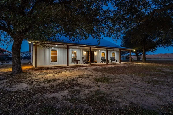 a view of a chairs and table in patio